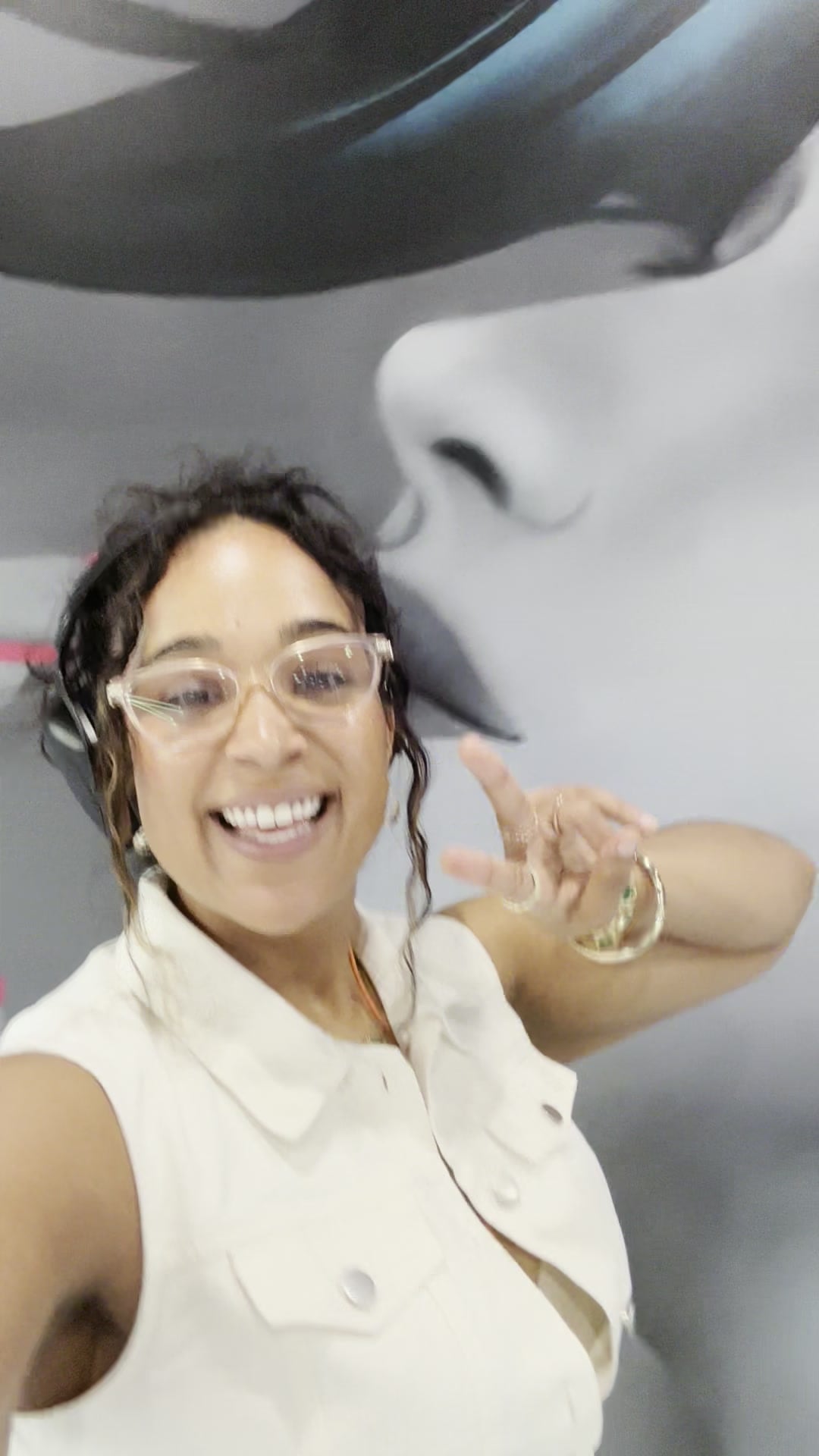 La Phiesa throwing a peace sign mid-set at the Kaya Bliss launch party, headphones round her neck