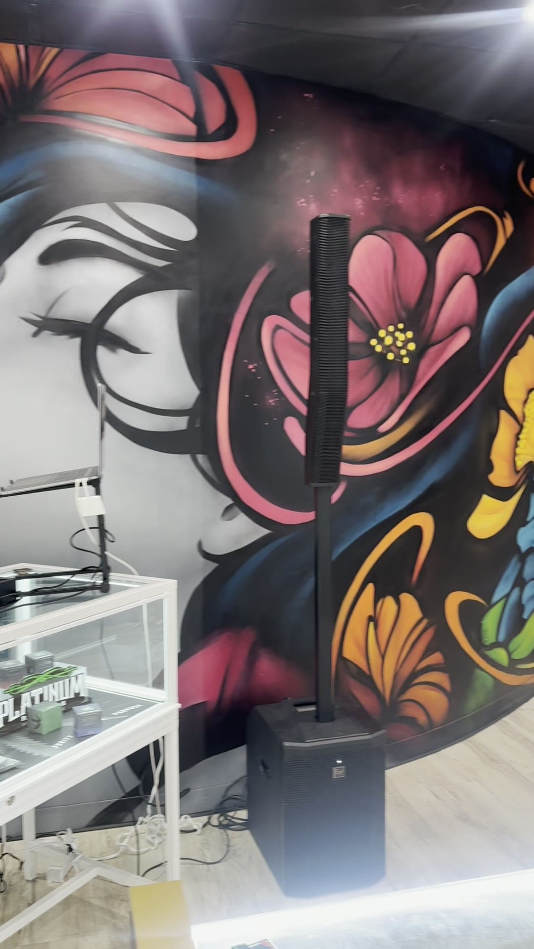 The floral mural and PA stack that framed the La Phiesa booth at the Kaya Bliss launch party