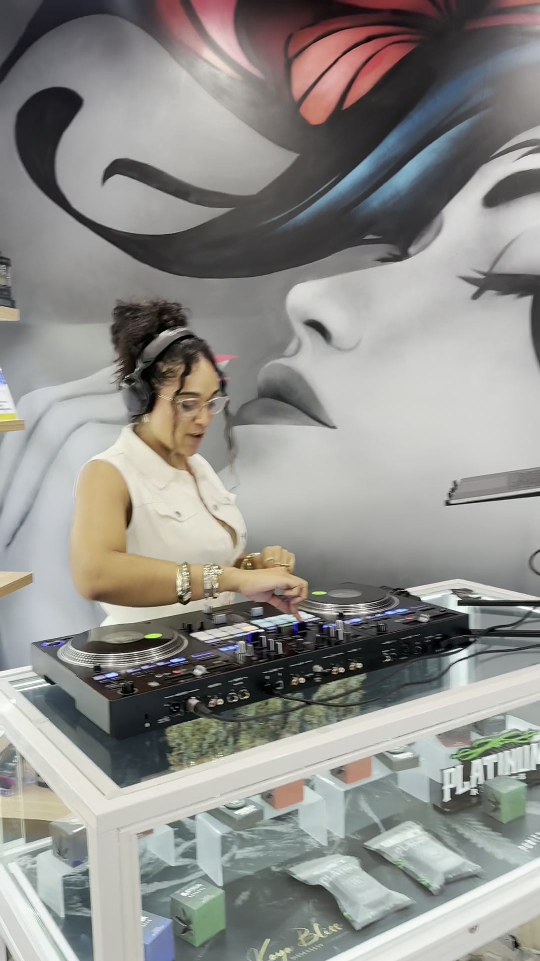 La Phiesa heads-down on the turntables at the Kaya Bliss launch party, the painted portrait mural filling the wall behind her