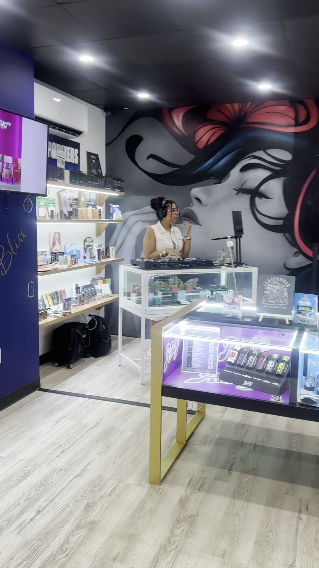 Wide view of the Kaya Bliss launch party room, La Phiesa holding the corner booth under the mural