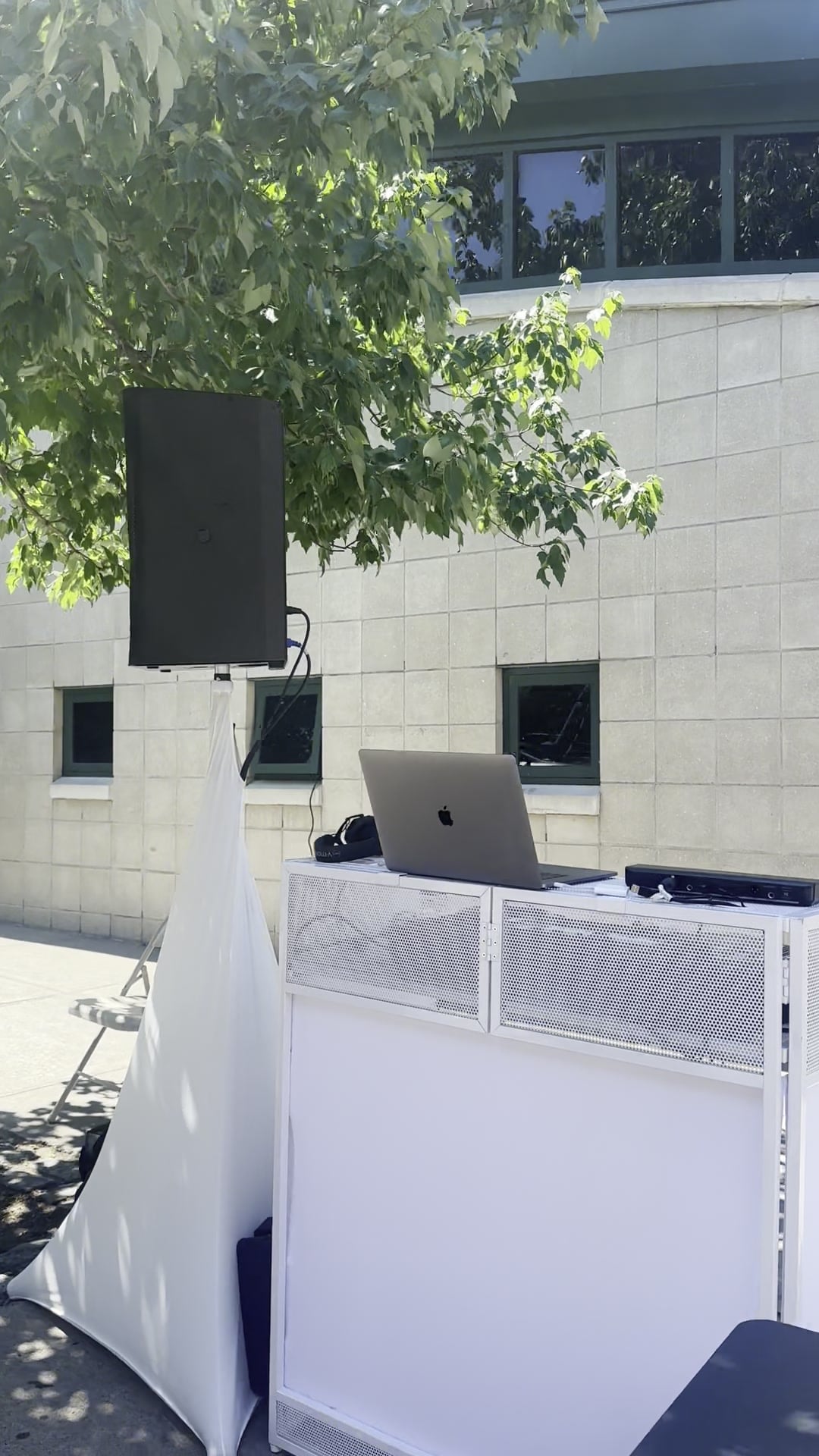 The La Phiesa rig set up outdoors for the Spring into Health block party, speaker on its stand under a shade tree