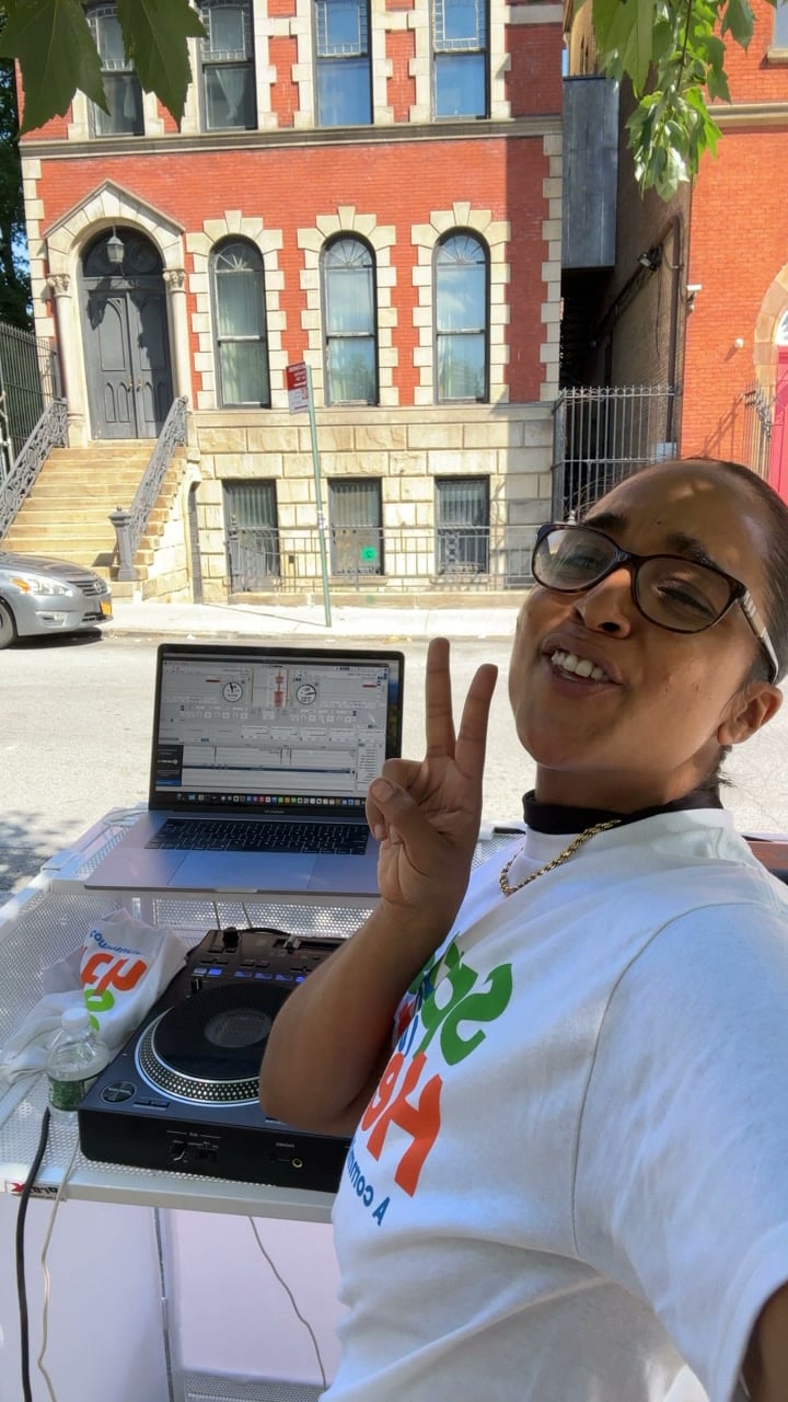 La Phiesa at the outdoor decks for the Spring into Health block party, waveform up on the laptop beside her