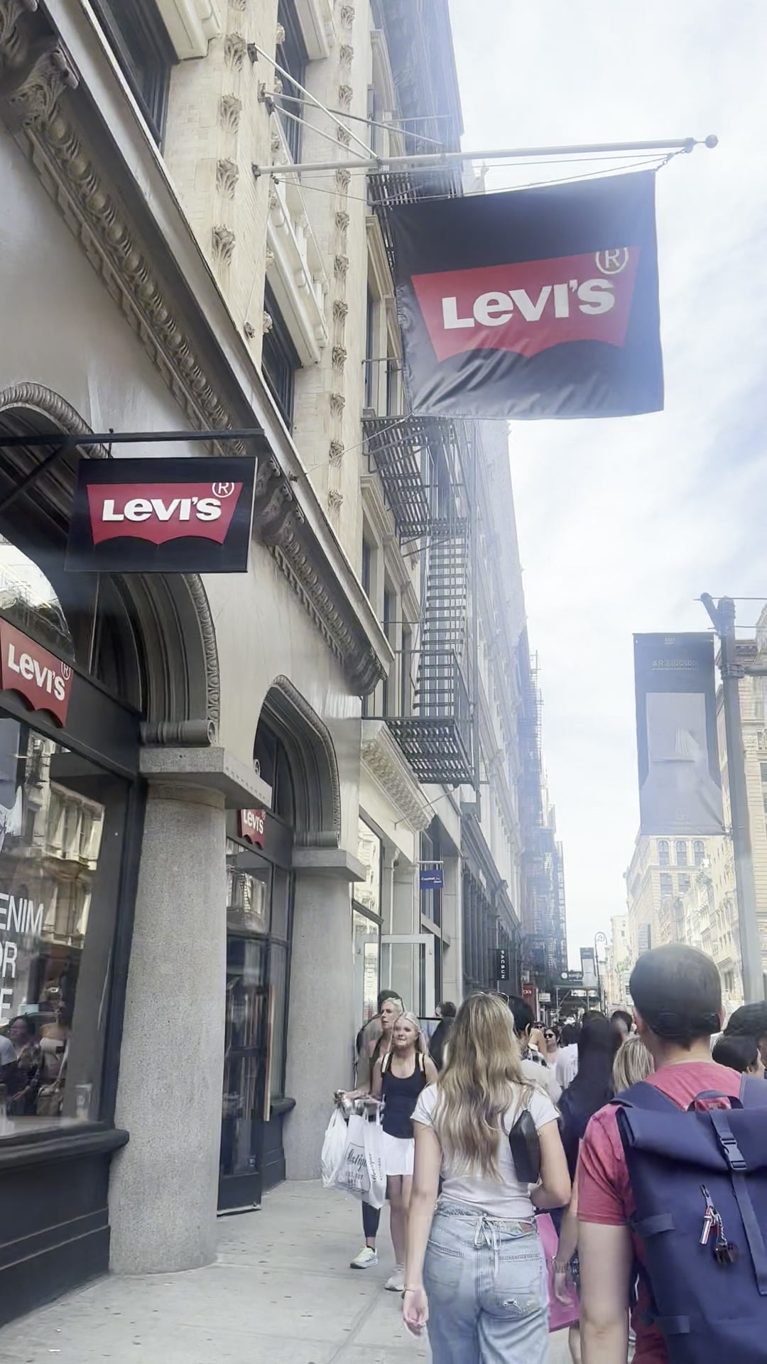 Levi's banners hanging above the cast-iron facade of the SoHo flagship store where La Phiesa played the Memorial Day weekend set