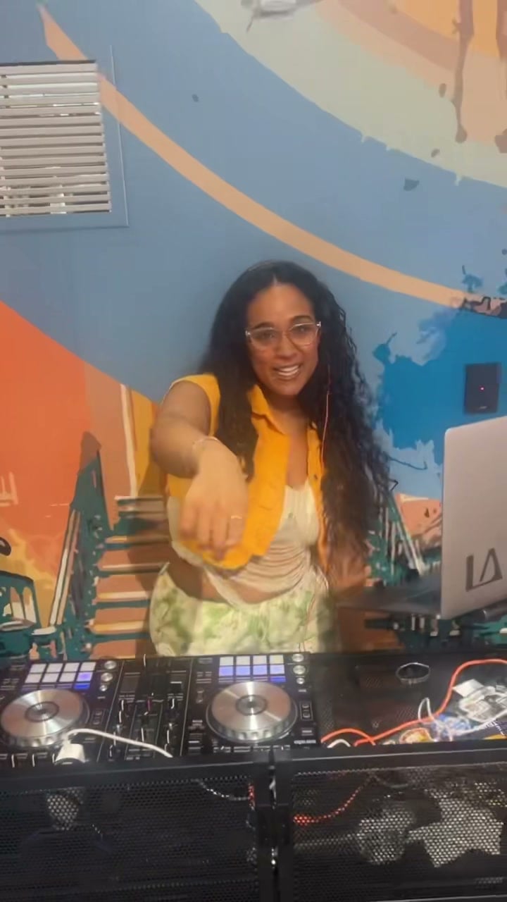 La Phiesa pointing out into the room mid-set at Stoops, controller and laptop laid out in front of her