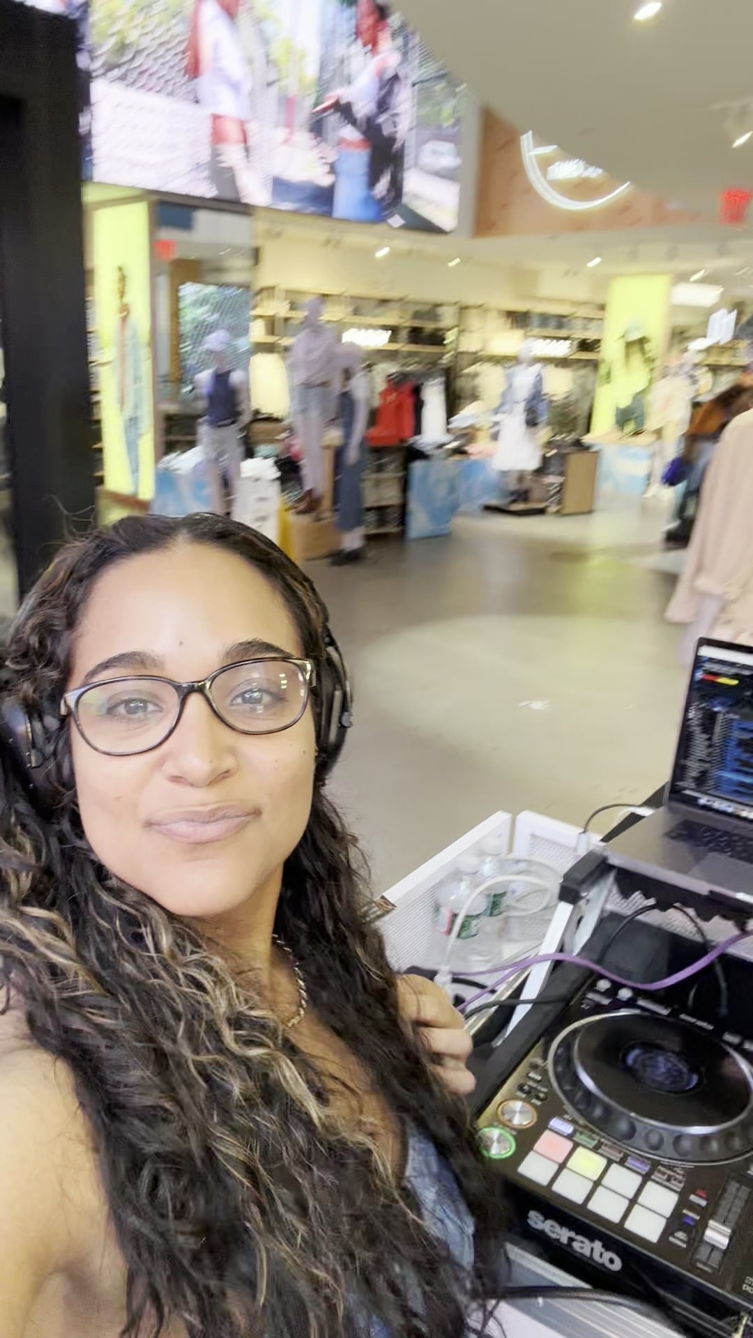 La Phiesa beside her controller and Serato rig on the shop floor of the Levi's Times Square store during the Cinco de Mayo activation