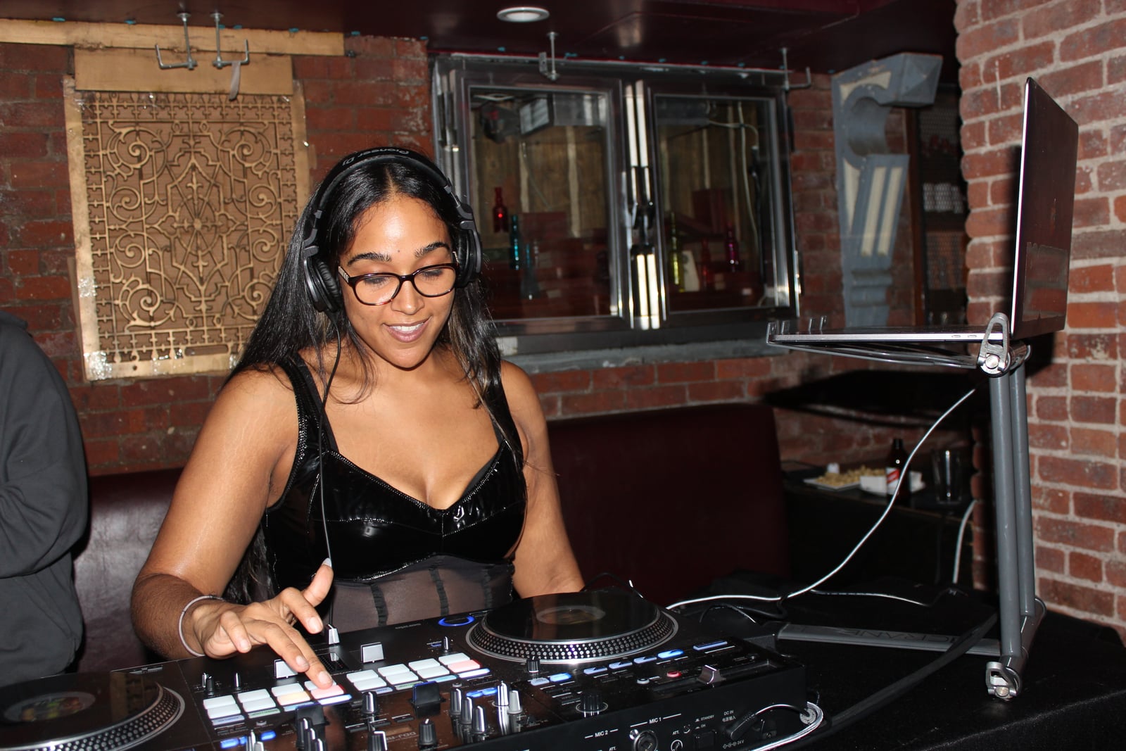 La Phiesa mixing behind the DJ booth during her set at The Tippler in Chelsea