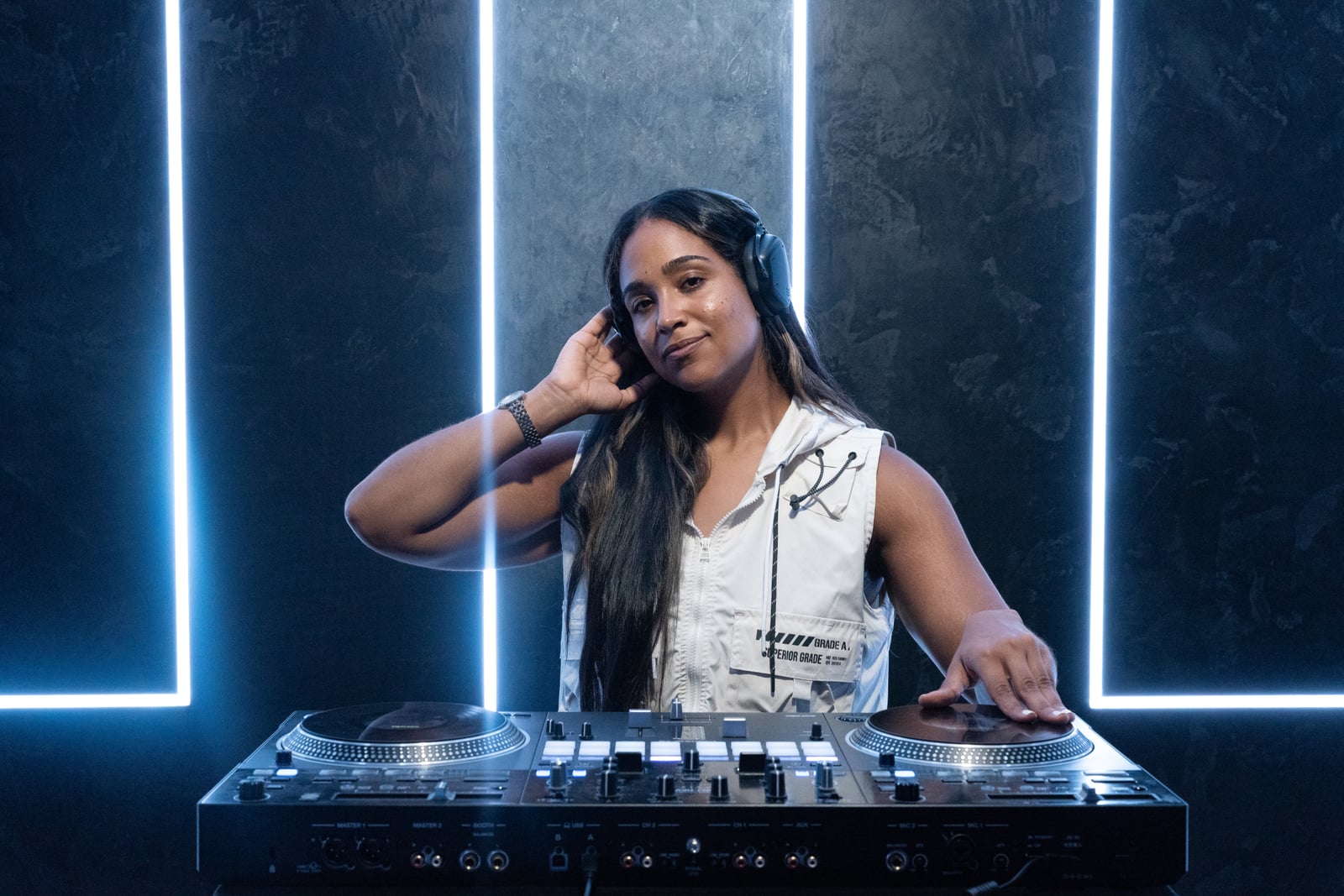 La Phiesa with both hands on the turntables, moody blue strip lighting